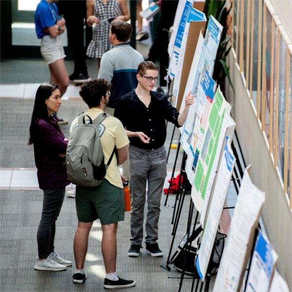 A student discusses his research during Student Scholars Day